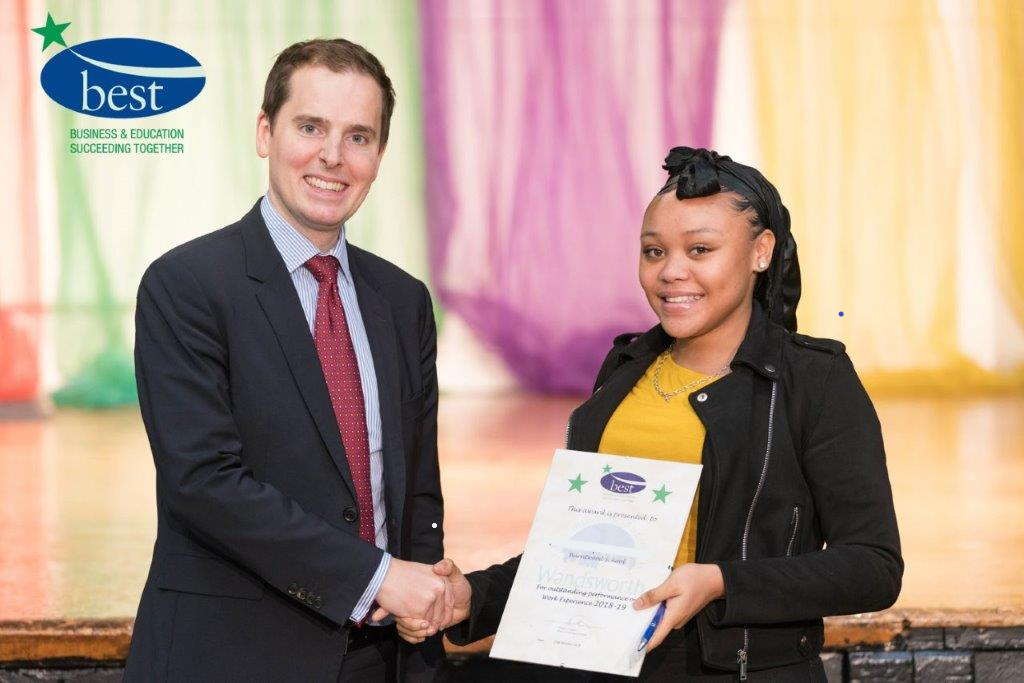 A man shaking hands with a woman holding a certificate after completing the Employability Course at Steps 2 Success.