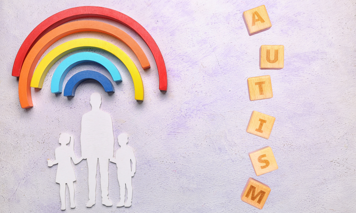 Silhouette of an adult and two children under a rainbow with the word "Autism" on the right