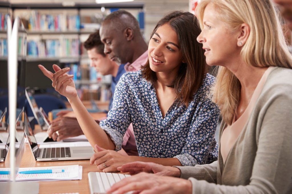 A woman tutor teaching an adult student why digital skills matter.