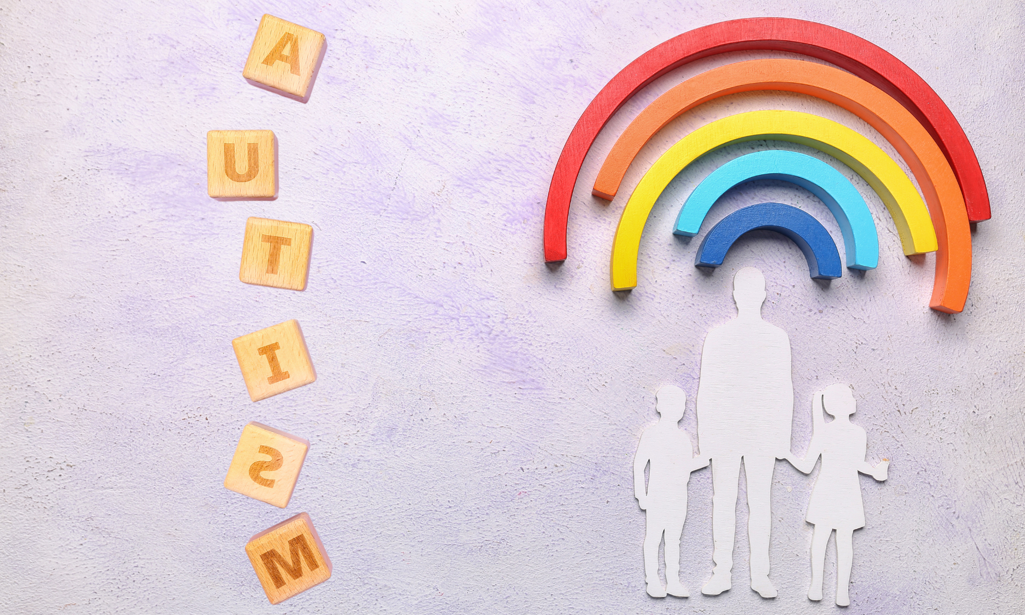 Understanding Autism course. Silhouette of an adult and two children under a rainbow.