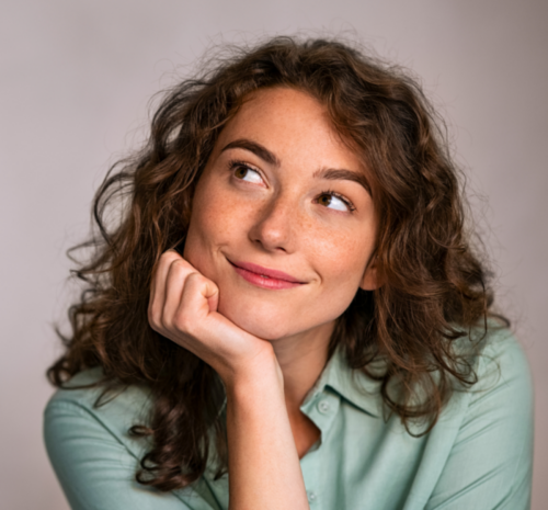 Get help finding a course - Head and shoulders of a woman smiling and thinking about her future.